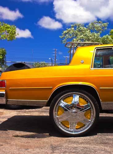gold Buick with huge spinners