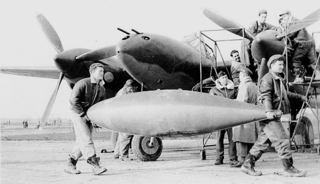 The 165 Gallon Lockheed Drop Tank in Front of a P-38 Lightning Fighter dated Nov 1943